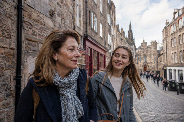 Mother and daughter walking side-by-side through a stone‑built Edinburgh street, natural candid moment on a tailor-made Girls' Trip with High Point Holidays.