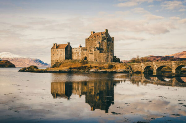 Historic Scottish castle surrounded by dramatic landscapes, featured in a tailor-made History & Heritage journey across Europe with High Point Holidays.