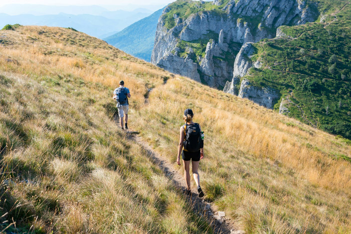 Couple hiking through the French countryside on a self-guided walking holiday in France.