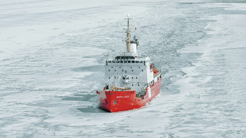 Arctic icebreaker sailing through the frozen Gulf of Bothnia in Swedish Lapland