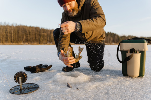 Traditional ice fishing on a frozen lake in Swedish Lapland
