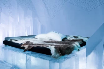 Ice room at the ICEHOTEL in Sweden with sculpted ice walls and unique Arctic design